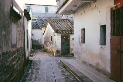 Empty alley amidst buildings in city