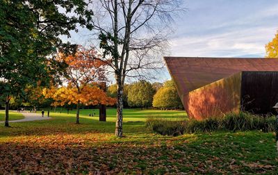 Trees on field against sky during autumn