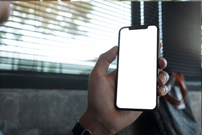 Close-up of hand holding smart phone