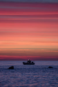 Scenic view of sea against orange sky