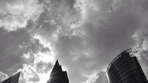 Low angle view of modern building against cloudy sky