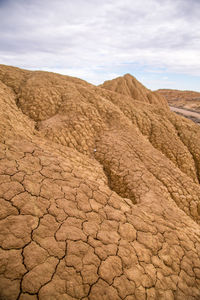 Scenic view of desert land against sky