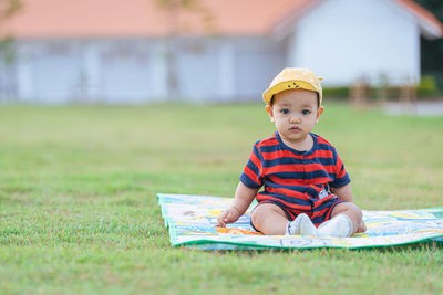 Asian children lounging in the green lawn