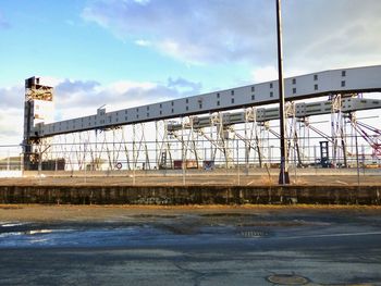 Bridge over river against sky in city