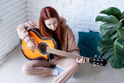 Young woman playing guitar