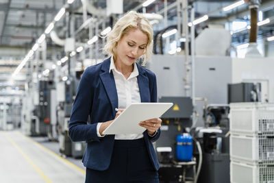 Inspector using tablet pc at automated industry