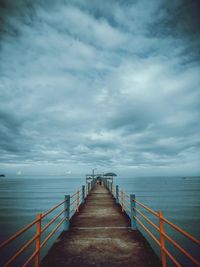 Pier over sea against sky