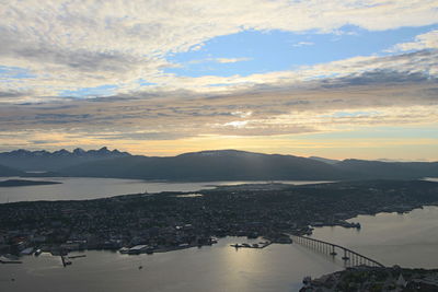 High angle view of city by sea against sky