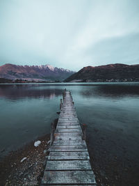 Pier over lake against sky in new zealand