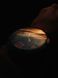 Close-up of human hand against black background