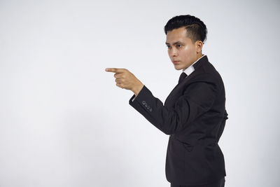 Side view of young man against white background