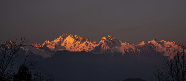 Scenic view of snowcapped mountains against sky at night