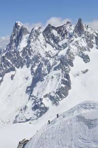 Scenic view of snow covered mountains against sky