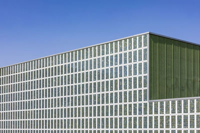 Germany, tuebingen, detailof modern multi-purpose hall paul horn-arena with solar panels