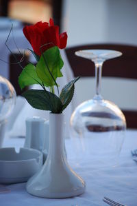 Rose in vase on table at restaurant