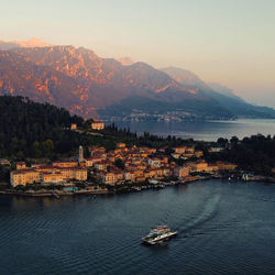 High angle view of townscape by sea against sky