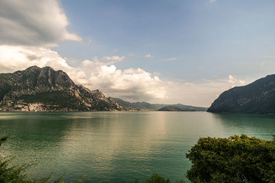 Scenic view of sea and mountains against sky