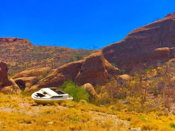 Car on road by mountain against clear sky