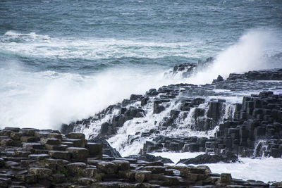 Waves splashing on rocks at shore