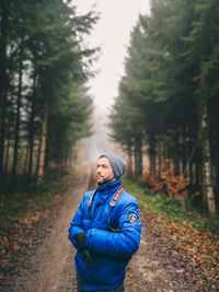 Young man standing in forest