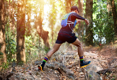 Full length of man running in forest