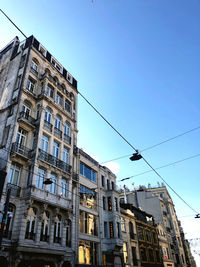 Low angle view of buildings against clear blue sky