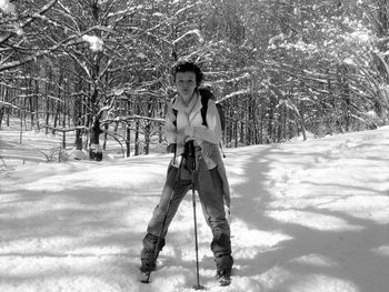 Portrait of woman standing on snow covered field