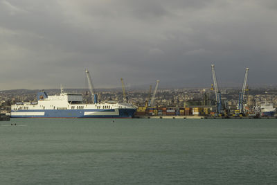 Commercial dock by sea against sky