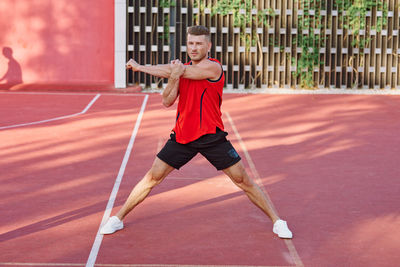 Full length of man playing tennis