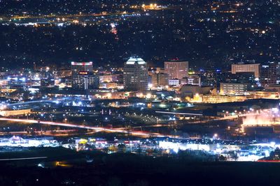 High angle view of illuminated buildings in city at night