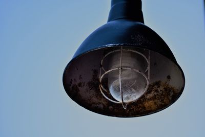 Low angle view of pendant light against clear sky