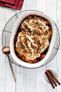 Top down view of a meringue topped sweet potato and beet baked vegetables.