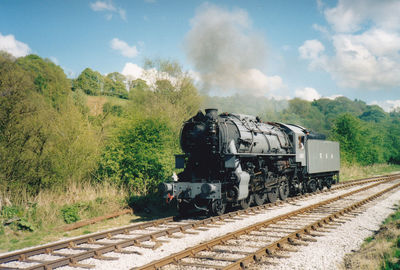 Train on railroad track against sky