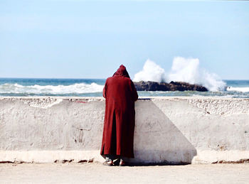 Rear view of red umbrella on beach