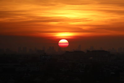 Silhouette buildings against sky during sunset