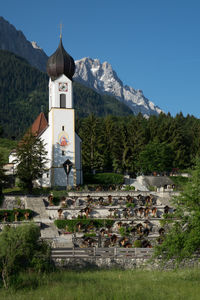 Traditional building by mountains against sky