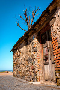 Exterior of old building against clear blue sky