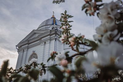 Low angle view of church against cloudy sky