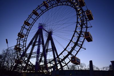 Low angle view of ferris wheel against clear sky