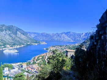 Scenic view of bay against clear blue sky