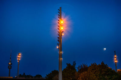 Low angle view of illuminated street light at night