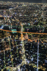 High angle view of city lit up at night