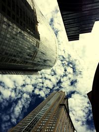 Low angle view of buildings against cloudy sky