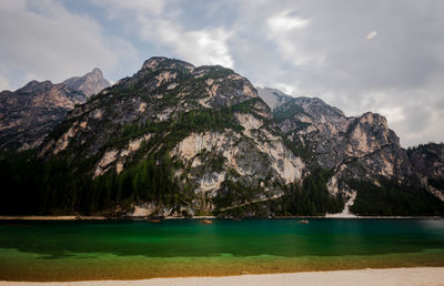 Scenic view of sea and mountains against sky