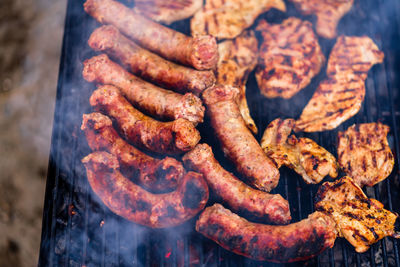 High angle view of meat on barbecue grill