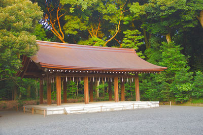 Gazebo in park by building in forest