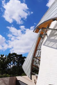 Low angle view of building against cloudy sky
