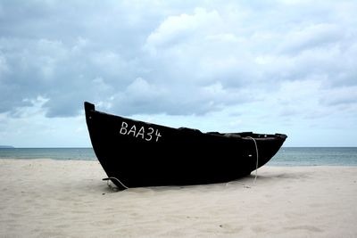 Boat on beach against sky