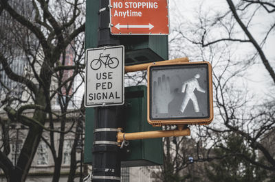 Low angle view of road sign against trees