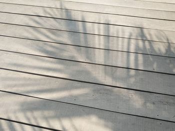 Low angle view of power lines against wall